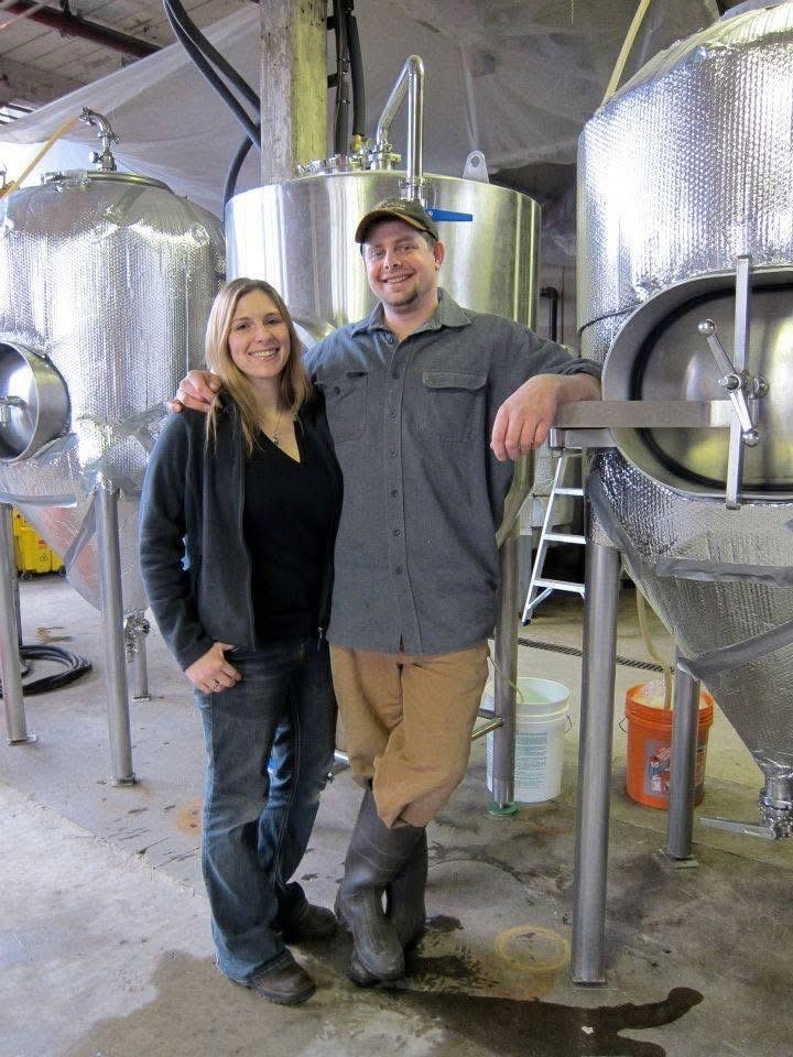 A Man and a Woman Standing together smiling at the camera